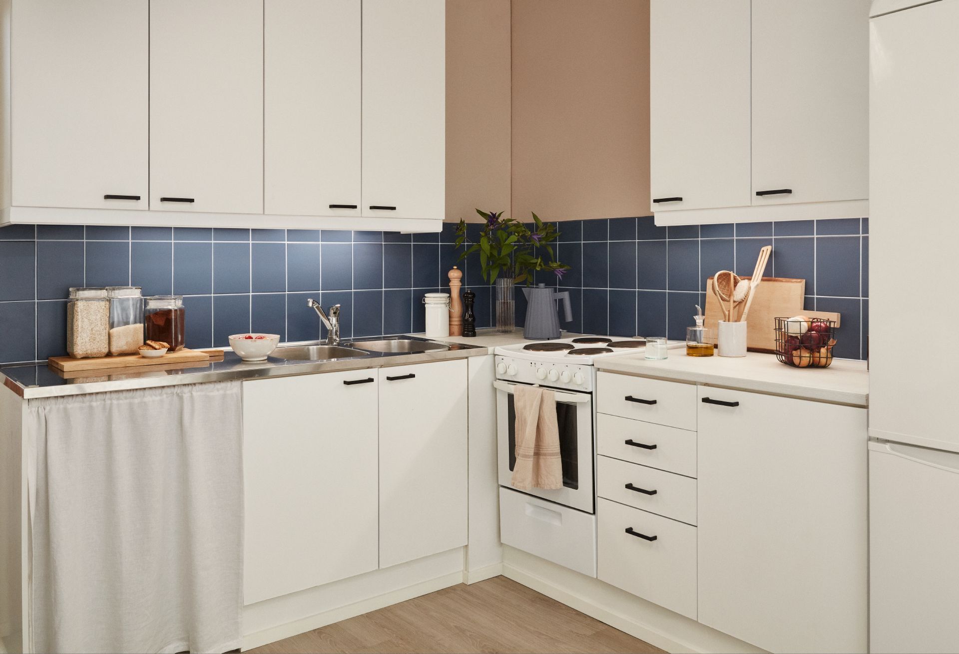 white kitchen with blue colour painted backsplash tiles