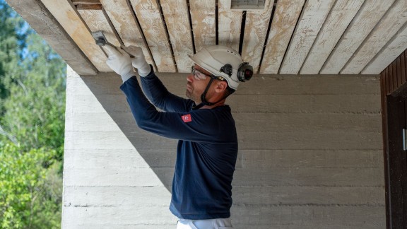 A painter preparing a wooden surface