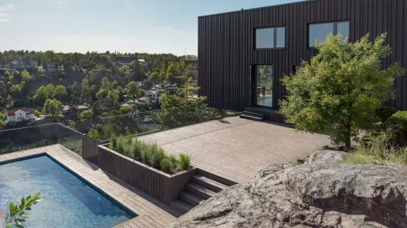 Dark wooden house with a terrace