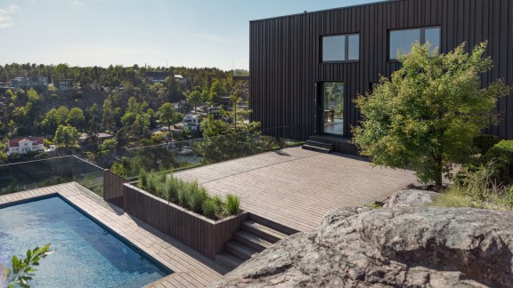 Dark wooden house with a terrace