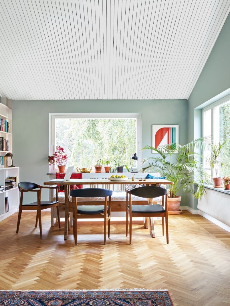 spacious living room with soft green colour wall