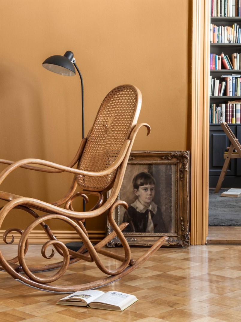 earthy yellow wall colour in living space with rocking chair