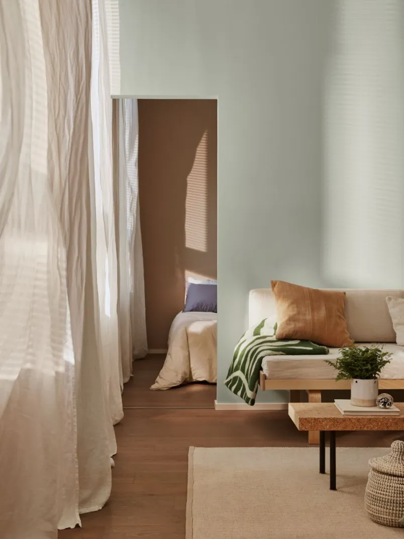 cosy living room with soft green wall 