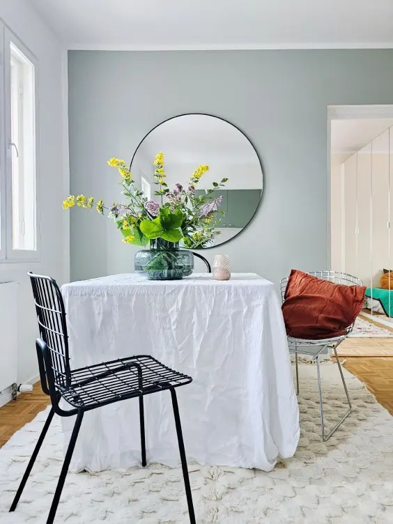 dinning room with little green accent wall