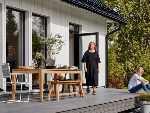white wooden house, woman and son on terrace