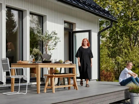 white wooden house, woman and son on terrace