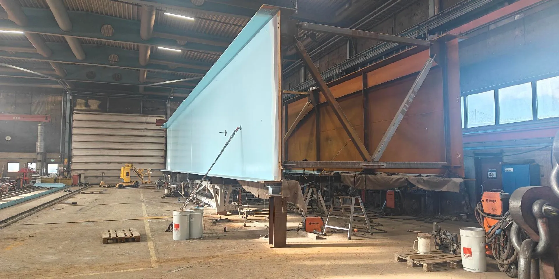Bridge elements are being painted indoors