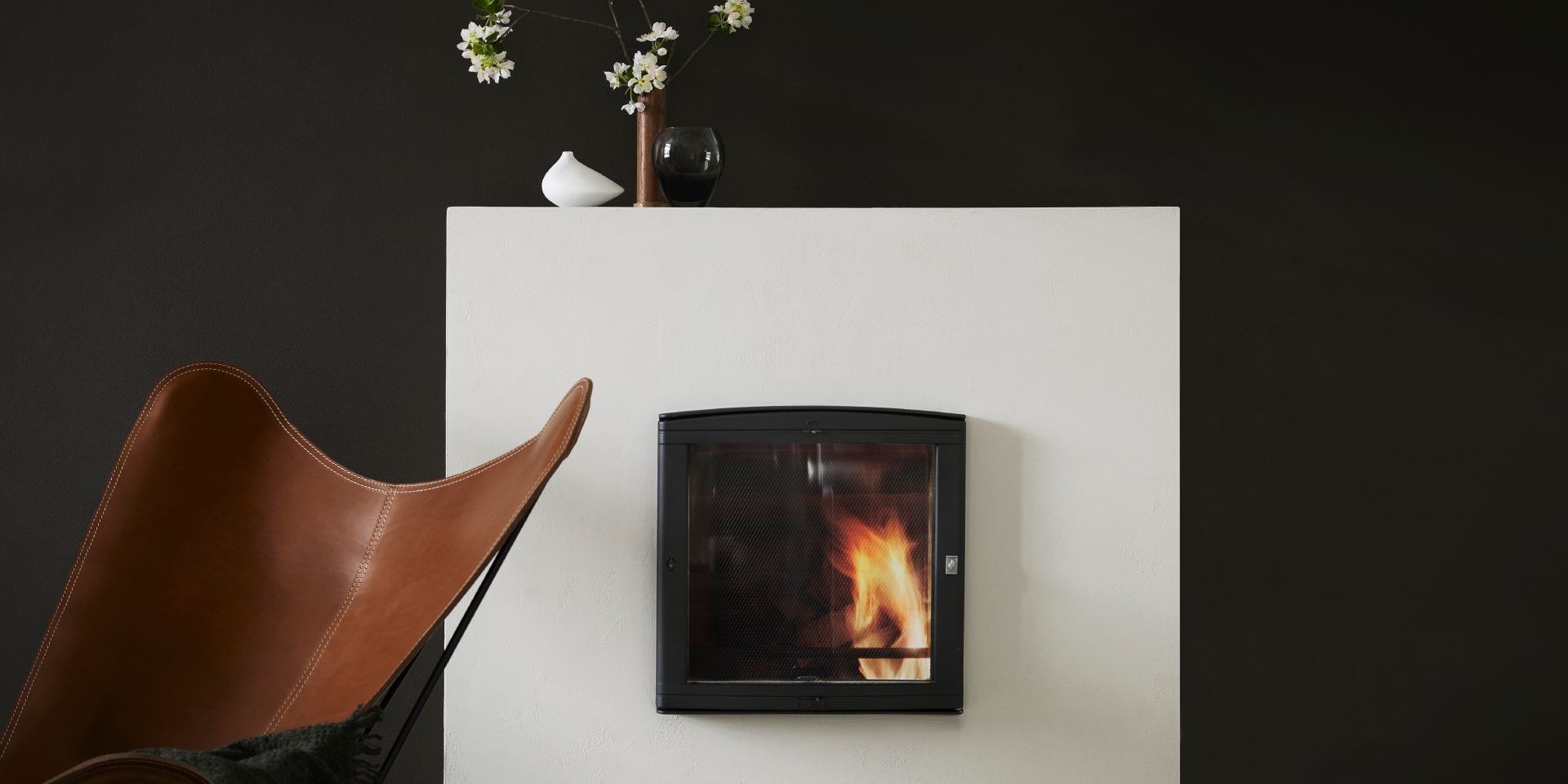 black wall behind white fireplace