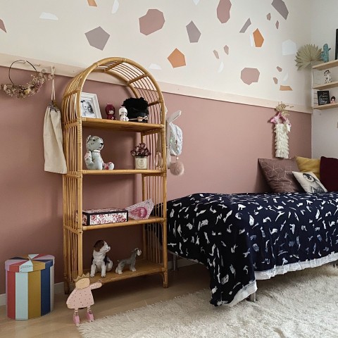 muted pink colour wall in kids room with colourful decorations