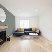 living room with green accent wall