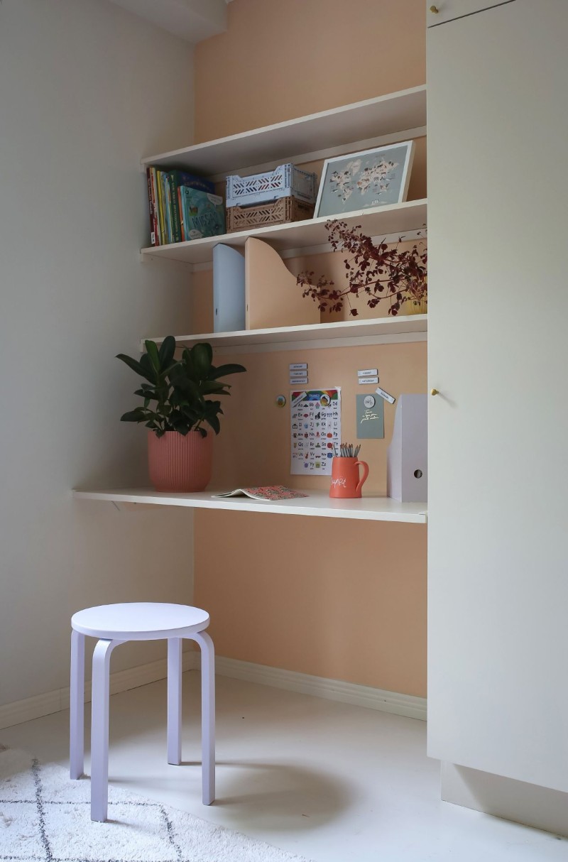 light beige colour wall and built in shelf with colourful items