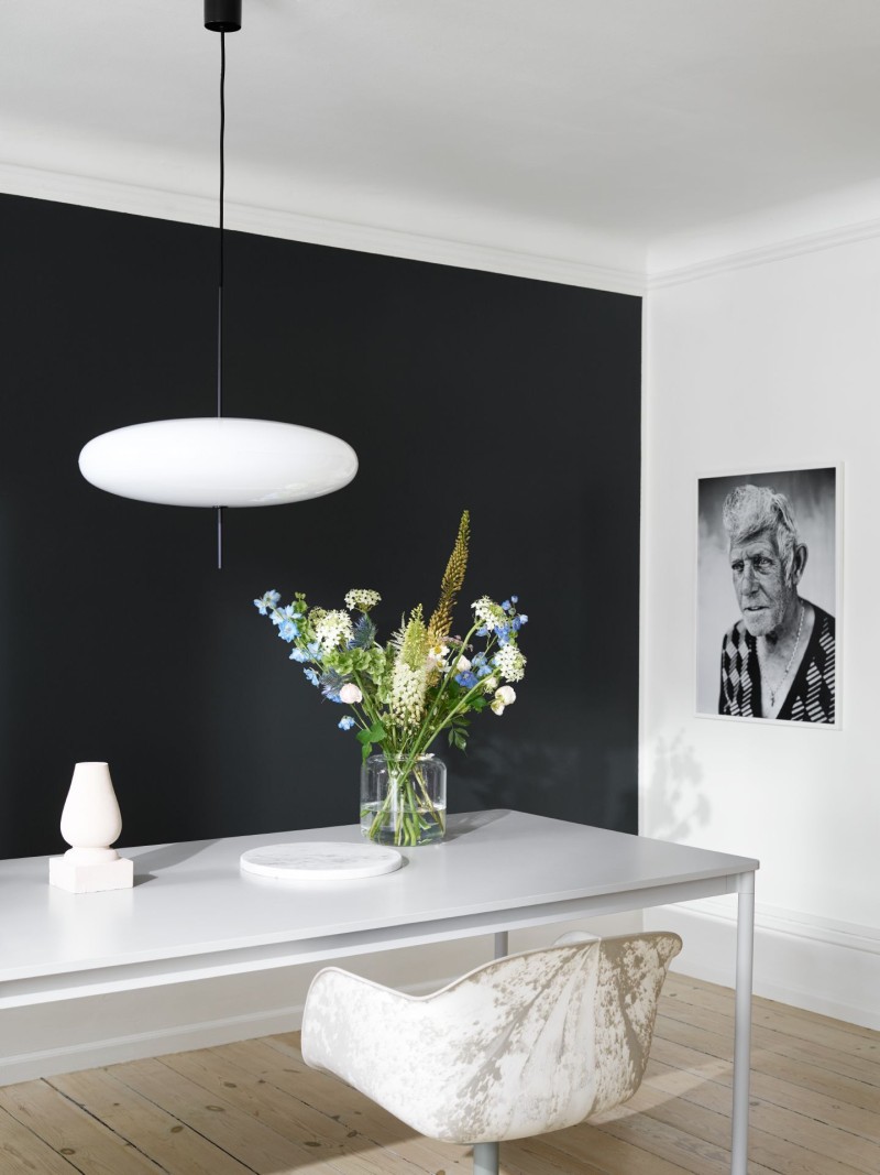 white dinning area with black accent wall