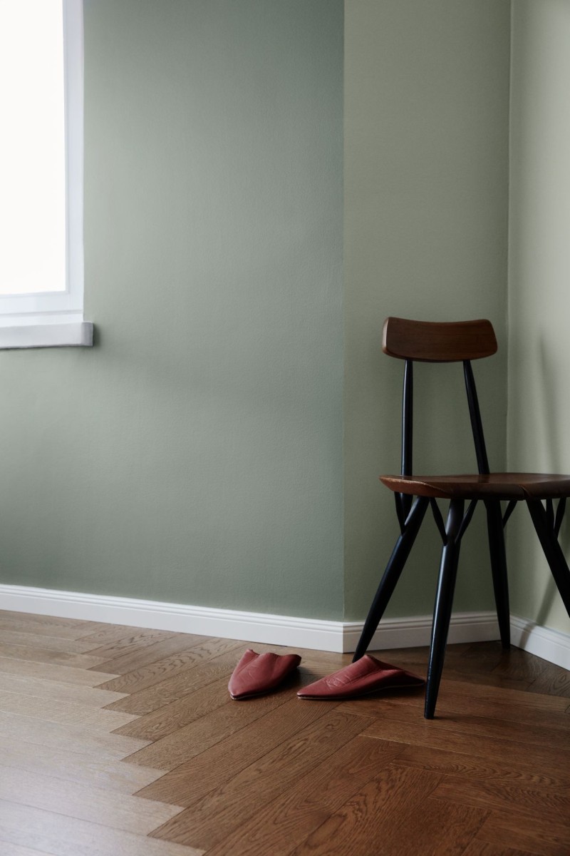 neutral green colour wall and dark wooden chair