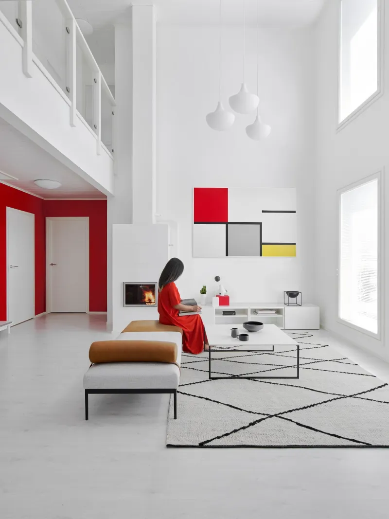 modern living room with white wall and bright red accent colour section