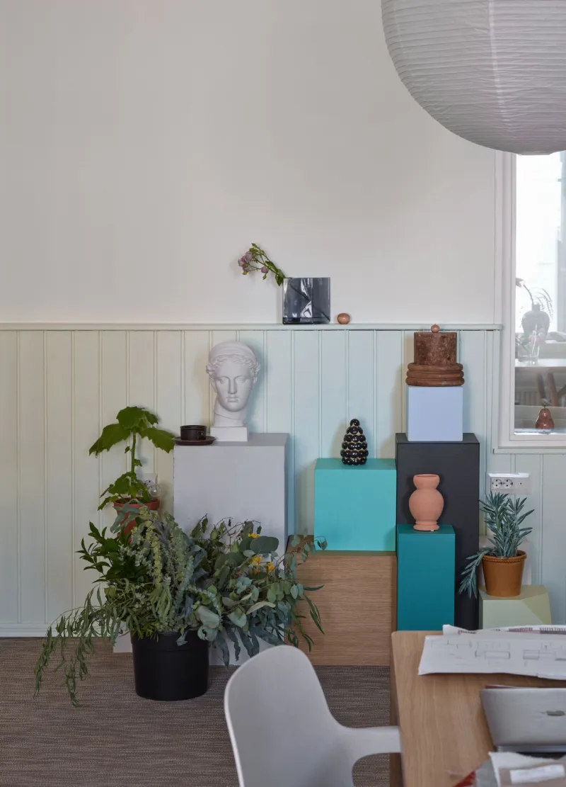 display area with colourful stands in front of half panel wall in light green colour