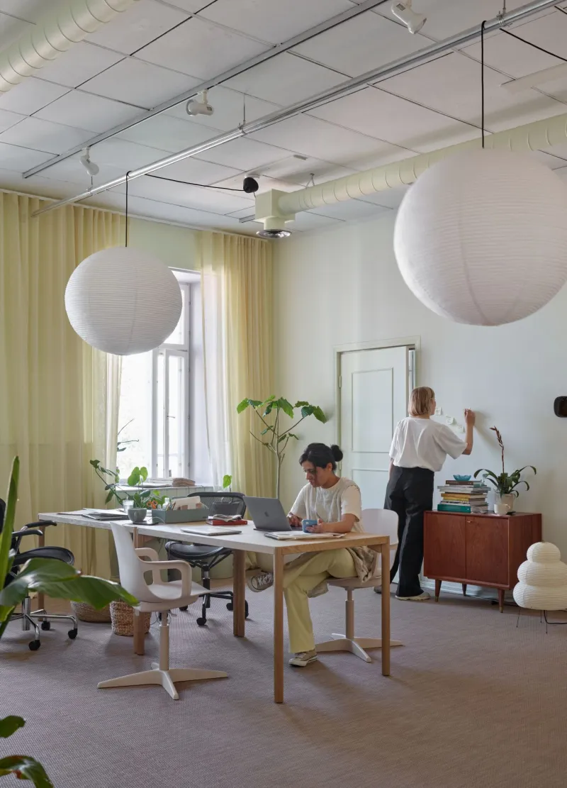 studio working area with muted colour walls, furniture and drapes 