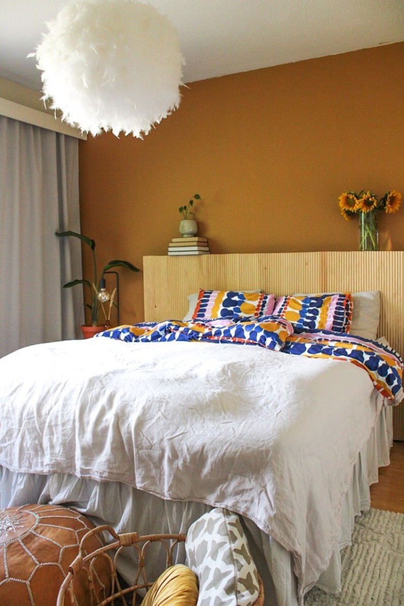 bedroom wall in warm yellow colour with matching beddings