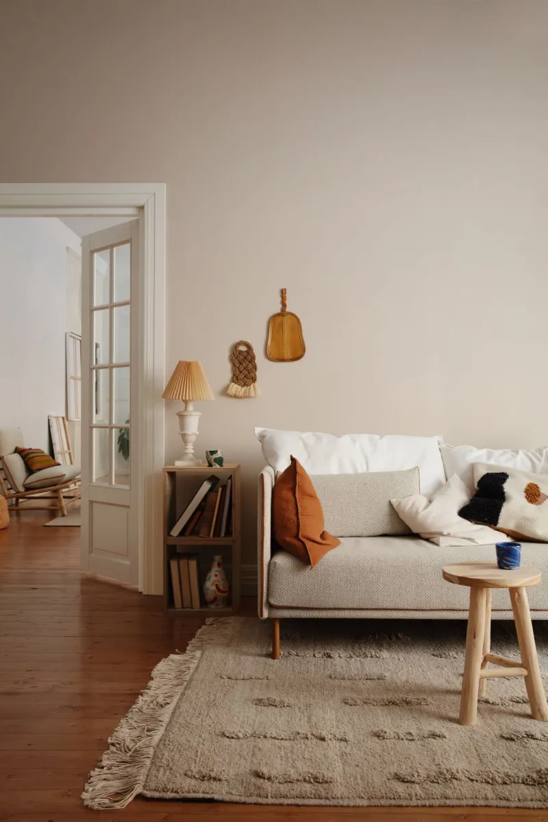 living room with beige colour wall and neutral earthy colour textile